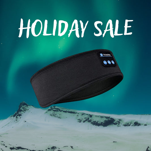 Black snow headband with ski headphones, promoting a holiday sale against a snowy backdrop and northern lights.